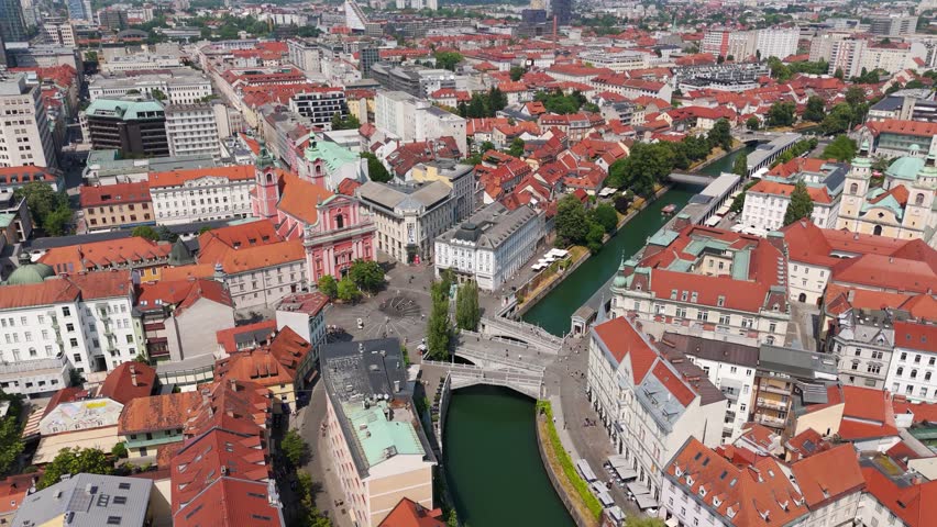 Aerial shot of iconic Ljubljana’s Triple Bridge with cityscape of City Center in Slovenia.