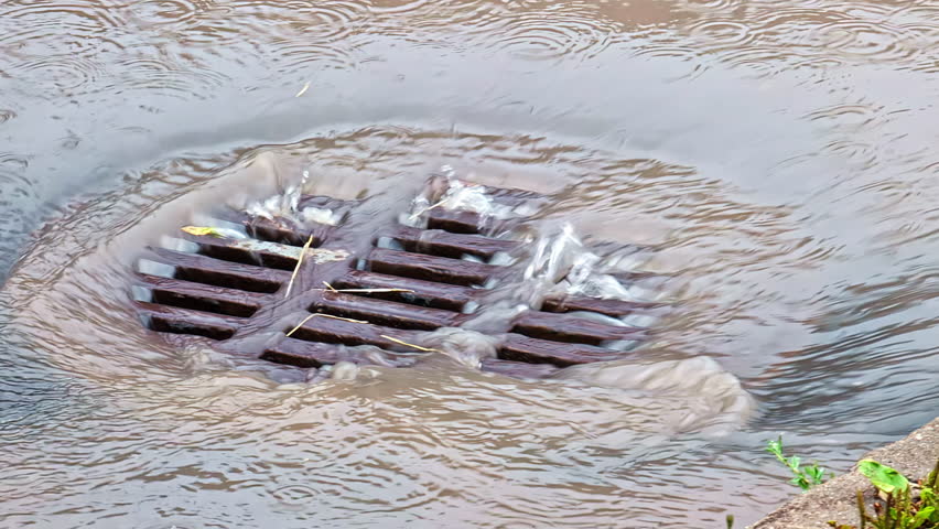 Storm drain catch basin surface drain during heavy rainfall, flood prevention rainy season