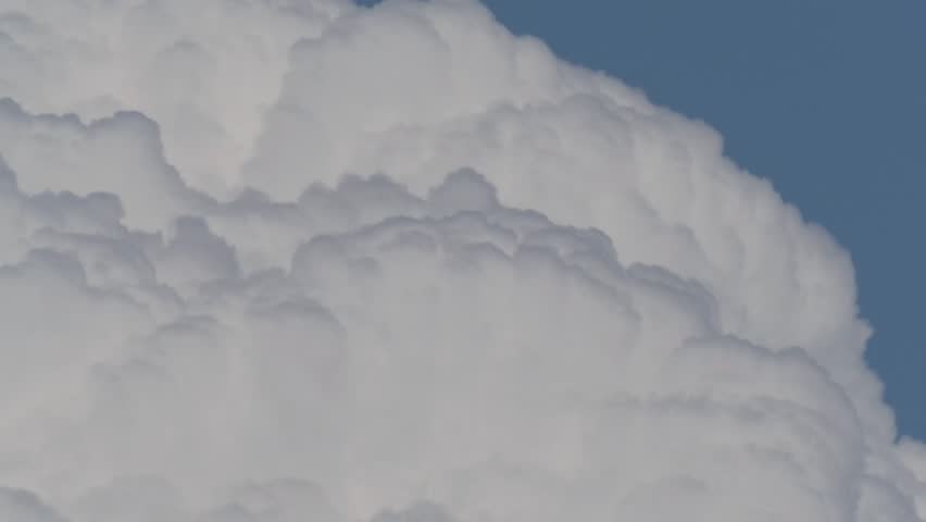 Quickly Moving cumulonimbus cloud or thunderhead on blue sky background in summer