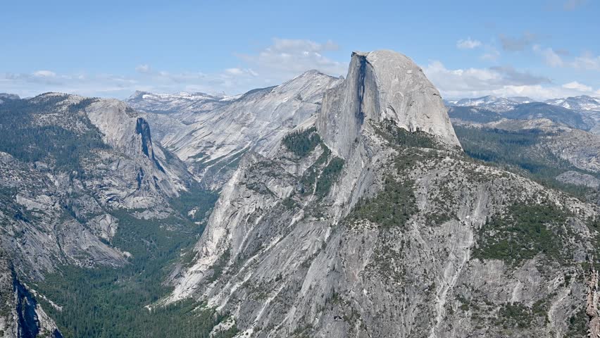Mariposa County, California, USA - May 26, 2025: View of Half Dome Peak and Yosemite Valley seen from Glacier Point in late afternoon.