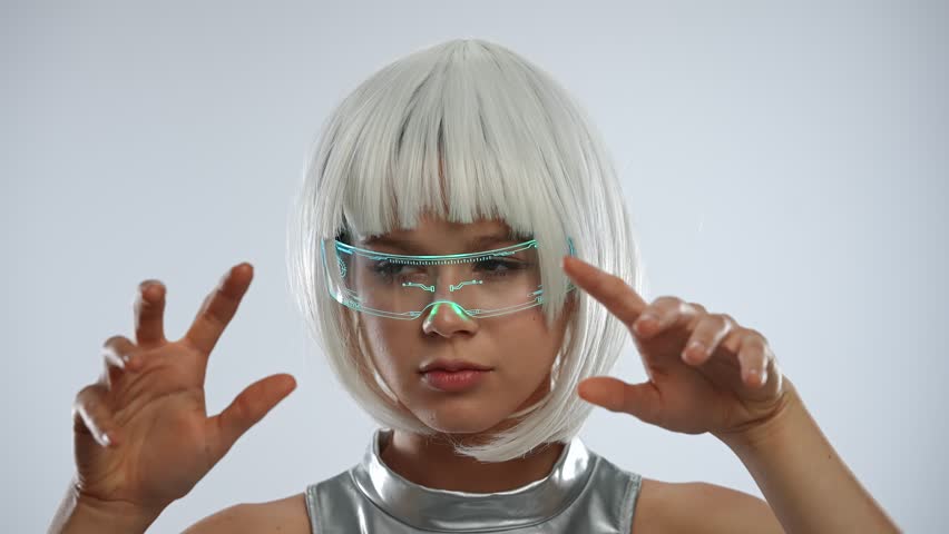 A futuristic woman with white hair, holographic smart glasses and silver clothes is typing on a virtual keyboard. She touches her fingers on a transparent digital interface. - Powered by Shutterstock - Get 15% off with code: PIKWIZARD15