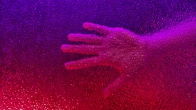 Close up of a hand pressed against frosted glass, illuminated by vivid red and purple lighting. The textured surface distorts details, creating an artistic, moody effect. - Powered by Shutterstock - Get 15% off with code: PIKWIZARD15