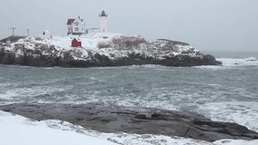 Nubble lighthouse in york, maine covered in snow on a cold winter day - Powered by Shutterstock - Get 15% off with code: PIKWIZARD15