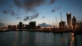 City skyline at night reflects in the water of the harbor with boats and ships - Powered by Shutterstock - Get 15% off with code: PIKWIZARD15