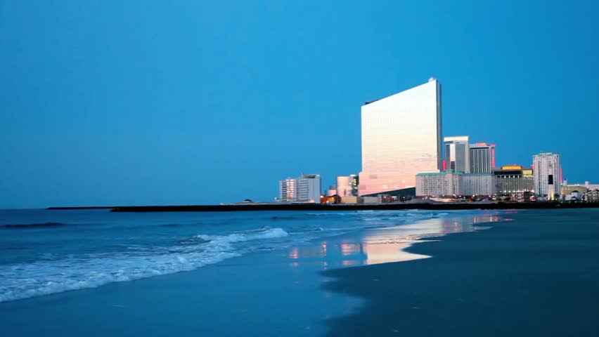 Atlantic city skyline at dusk with the ocean and beach in the foreground