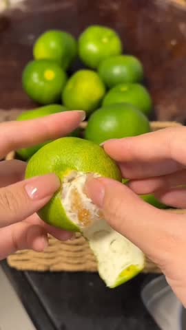 Peeling Fresh Green Mandarin Orange.