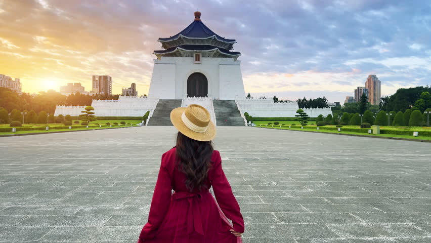 Asian woman walking at Chiang Kai Shek Memorial Hall in Taipei, Taiwan.
