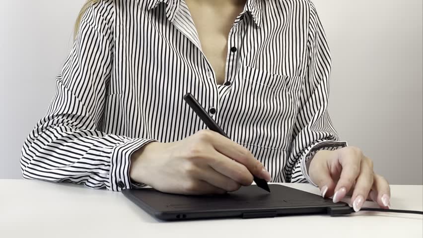Creative business woman graphic designer working with stylus on digital tablet at modern bright office desk. Freelance artist drawing illustration. Creative professions and productivity concept video