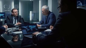 Executives Gather Around a Conference Table, Analyzing Global Data on Laptops and Discussing Strategic Objectives. Participants Take Notes, Review Charts, and Collaborate on Corporation Meeting Topic - Powered by Shutterstock - Get 15% off with code: PIKWIZARD15