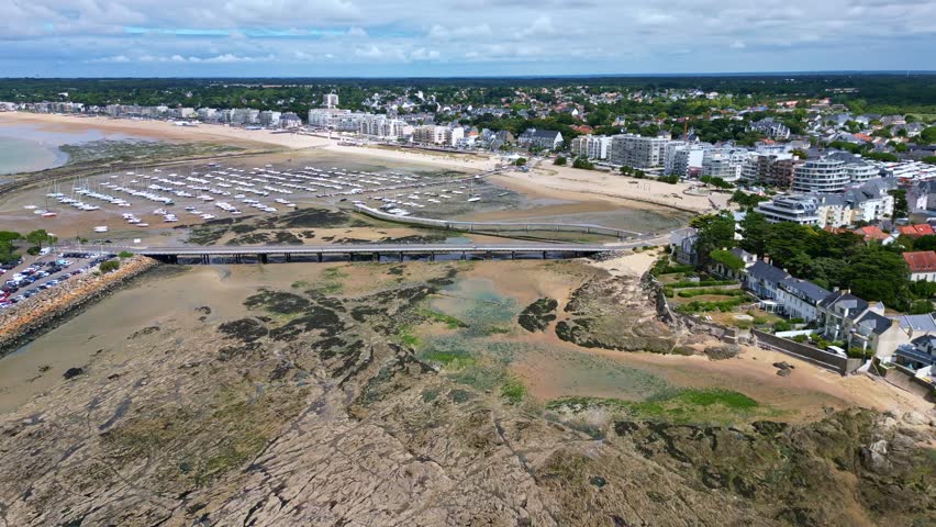 Panorama drone view of the Port de Plaisance muddy tidal beachfront and Libraires Beach aka Plage des Libraires, low tide, Pornichet, Loire-Atlantique, France.
