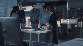 Several Individuals Gather at a Central Table, Reviewing Printed Schematics and Digital Displays. the Group Discusses Technical Data, Referencing Diagrams, Engineering Analysis  - Powered by Shutterstock - Get 15% off with code: PIKWIZARD15