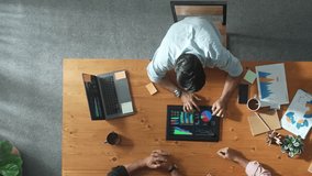 Diverse Professionals Working on Business Statistics and Marketing Plans in Corporate Office. Top Down View Discussion and Financial Data Analysis on Laptops and Charts. Teamwork Innovation man woman - Powered by Shutterstock - Get 15% off with code: PIKWIZARD15