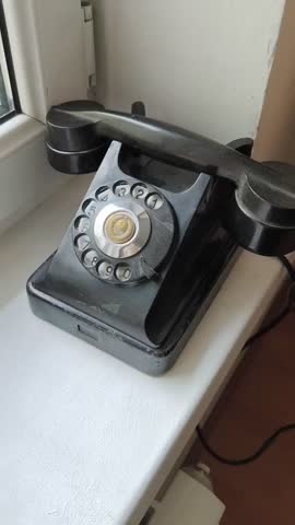 Vintage Rotary Dial Telephone on Windowsill in Natural Light
