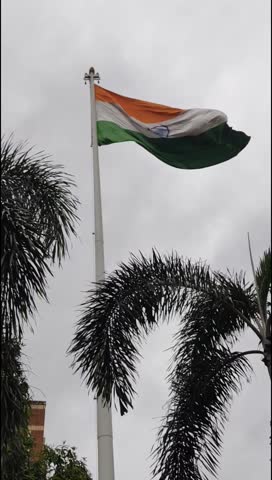 India flag flying high at Connaught Place with pride with plain white background, India flag fluttering, Indian Flag on Independence Day and Republic Day of India, tilt up shot, Har Ghar Tiranga