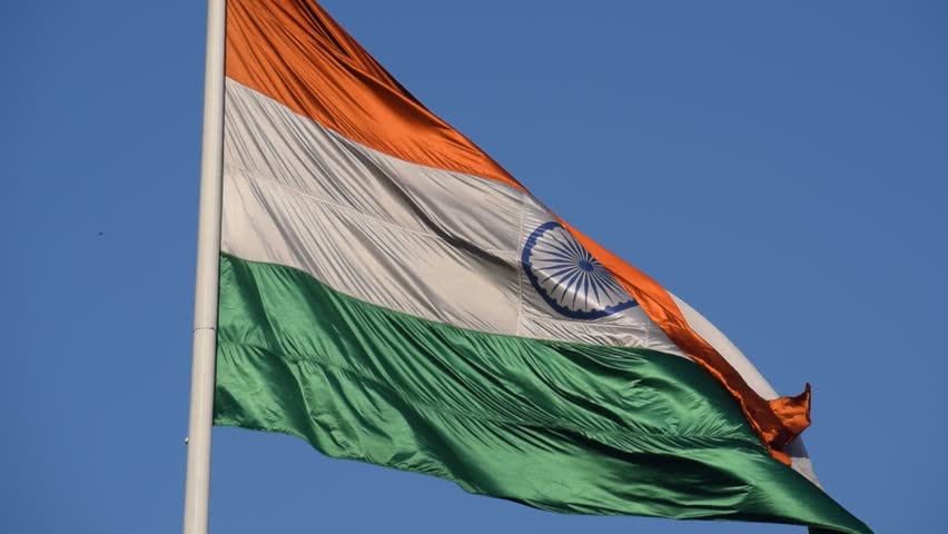 India flag flying high at Connaught Place with pride with plain white background, India flag fluttering, Indian Flag on Independence Day and Republic Day of India, tilt up shot, Har Ghar Tiranga