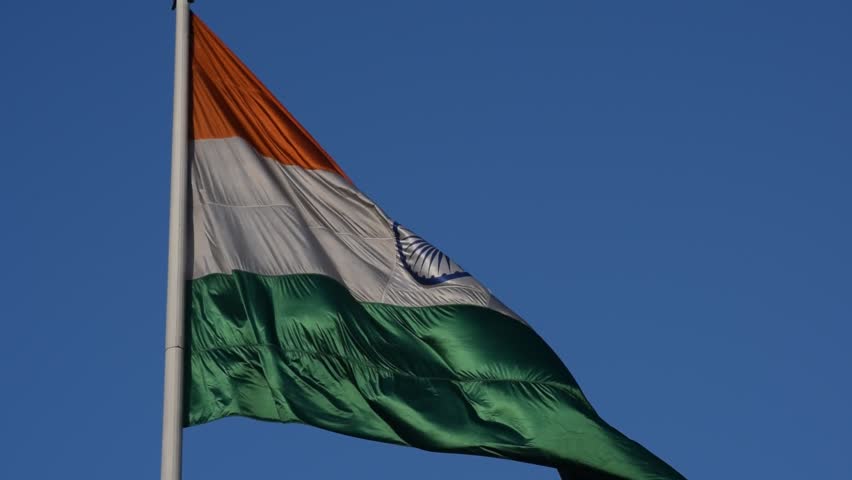India flag flying high at Connaught Place with pride with plain white background, India flag fluttering, Indian Flag on Independence Day and Republic Day of India, tilt up shot, Har Ghar Tiranga
