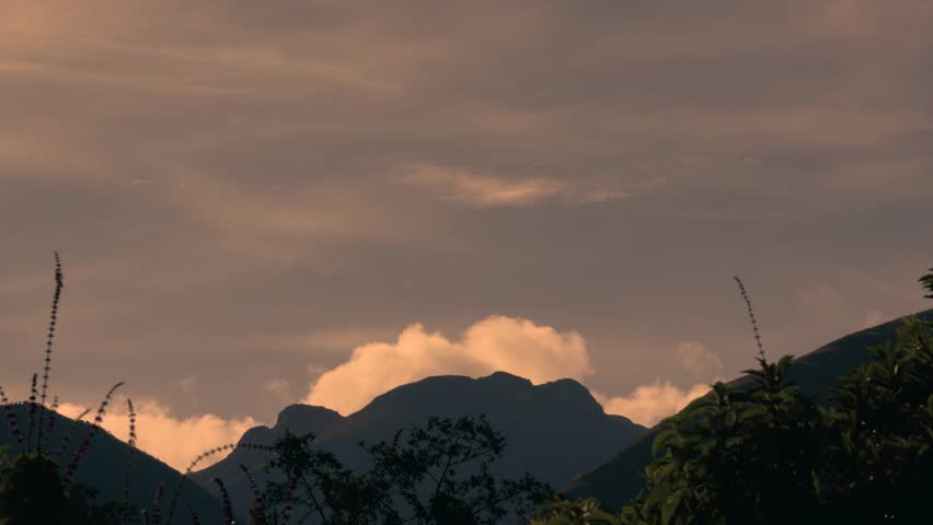 Time lapse of cumulus clouds rolling over the Iguaque mountain as a thick fog falls on the valley at sunrise, in the eastern Andean mountains of central Colombia, near the town of Villa de Leyva.