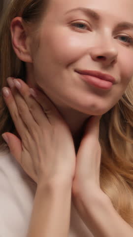 Pretty Caucasian young woman massaging neck face cream beauty routine at home beautiful model girl female touching skin applying serum cream lotion moisturizer skincare treatment antiaging cosmetics