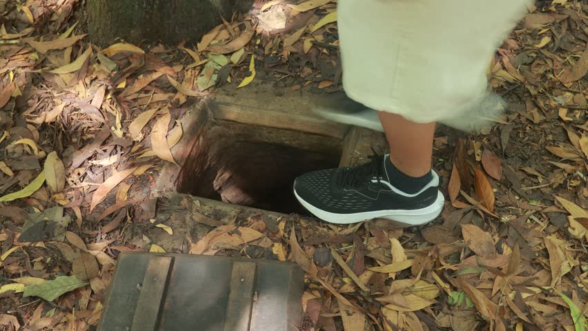 Tourist at the entrance of Cu Chi Tunnels in Ho Chi Minh, Vietnam, close up