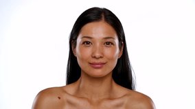 A portrait of a woman with a small heart tattoo on her shoulder, showcasing a serene and smiling expression. - Powered by Shutterstock - Get 15% off with code: PIKWIZARD15