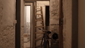 Basement hallway with rough stone walls a wooden ladder leaning against the wall and a bicycle parked nearby creating a rustic and slightly cluttered storage atmosphere - Powered by Shutterstock - Get 15% off with code: PIKWIZARD15