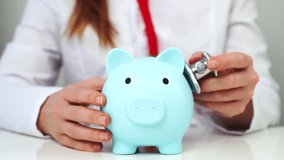 A Doctor Woman Holding a Piggy Bank in Her Hands. Concept of additional medical insurance. Lca - Powered by Shutterstock - Get 15% off with code: PIKWIZARD15
