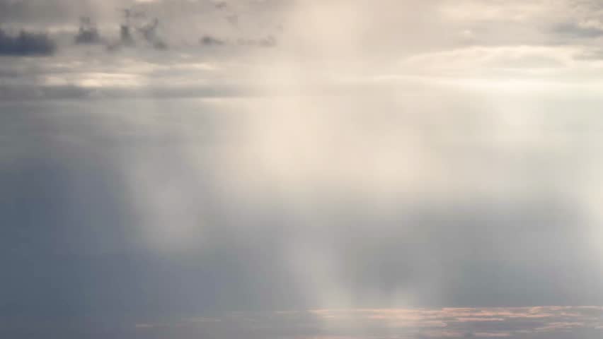 Stunning view from Dadao Mountain Shulin Taiwan. Dramatic light rays penetrate rain clouds over Taipei city skyline creating mystical atmosphere.