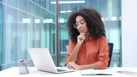 Thoughtful young African American businesswoman thinking about problem solving typing on laptop at workplace in office. Serious black woman employee is working on computer on project, busy with tasks - Powered by Shutterstock - Get 15% off with code: PIKWIZARD15
