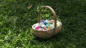 Vertical video. A Woman Holds a Basket Brimming with Colorful Easter Eggs and Flowers, Walking Through a Sunlit Field. Slow motion. - Powered by Shutterstock - Get 15% off with code: PIKWIZARD15