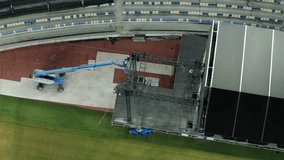 Music concert stage set up buildup construction. stadium football pitch being prepared to host a music concert. sports stadium as technicians set up the stage for the live music event. - Powered by Shutterstock - Get 15% off with code: PIKWIZARD15