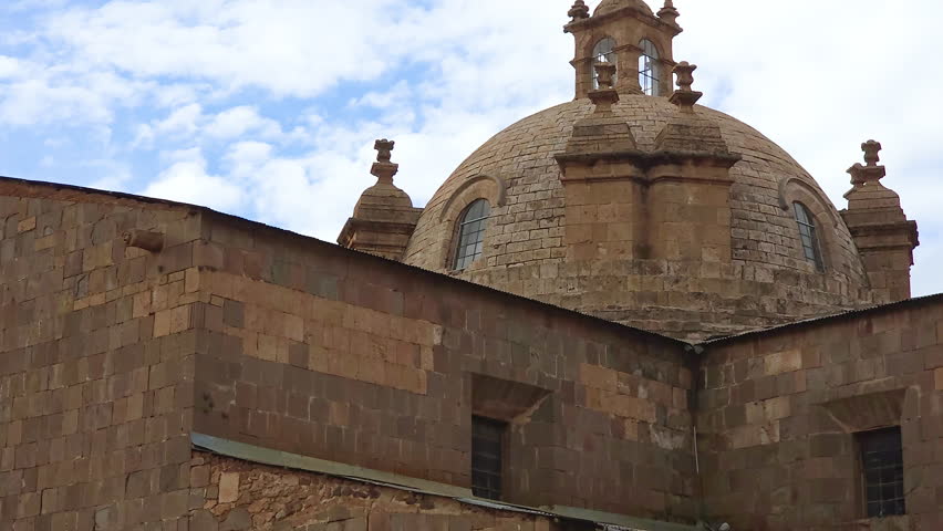 A detailed view captures the impressive central dome of the Cathedral Basilica of Puno, Peru. This architectural masterpiece showcases the intricate colonial design.