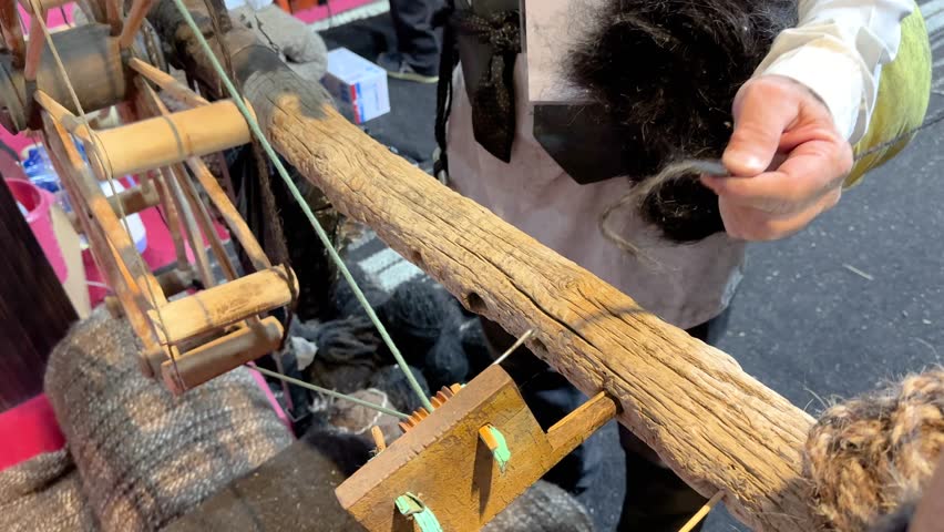 Traditional wooden spinning wheel tools spin Goat wool to make weaving fiber Handmade textile craft of Antique yurt cover Nomad art Iran Mongolia Village workshop retro skill handwork yarn material