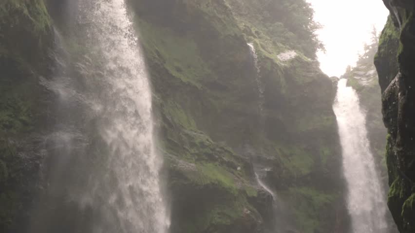 Powerful waterfall Quebrada Gata cascading down a moss-covered, rocky gorge.