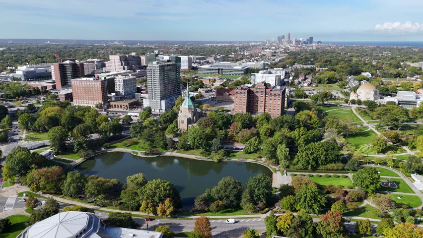 Cleveland, Ohio USA. Drone Shot of Church, Lagoon and University Campus Buildings With Downtown in Background