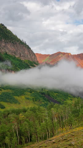 Vertical Timelapse, Clouds and Fog Moving Above Mountain Valley and Peaks, Crested Butte Colorado USA