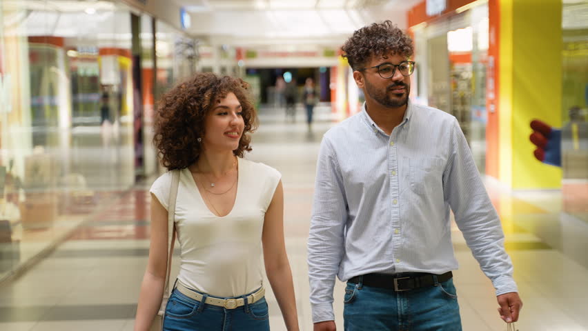 Happy couple walking in mall gallery