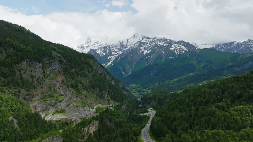 Aerial view of the road to Chamonix and snowy Mount Blanc, summer in France