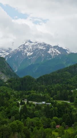 Vertical drone shot of rising toward the snowy Mount Blanc massif, in France