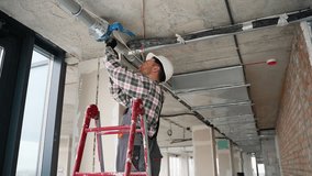 A plumber installs a fire safety system - Powered by Shutterstock - Get 15% off with code: PIKWIZARD15