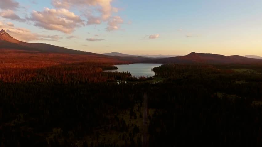 Scenic landscape of a lake and mountains at sunset with beautiful sky