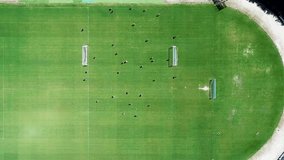 A wide aerial shot of a sports field with many players in motion energy and youth concept - Powered by Shutterstock - Get 15% off with code: PIKWIZARD15