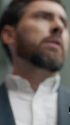 Shocked confused annoyed Caucasian male guy businessman business man in office looking smartphone reading bad news upset with mobile phone frustrated stressed failure app sad negative work problem