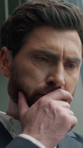 Shocked confused annoyed Caucasian male guy businessman business man in office looking smartphone reading bad news upset with mobile phone frustrated stressed failure app sad negative work problem