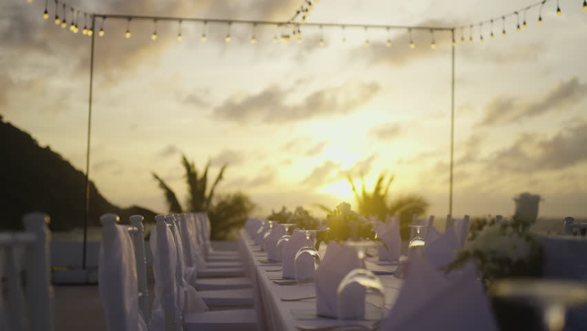 Merry set up party romantic reception. Wedding beach decor candle catering dinner luxury event.
