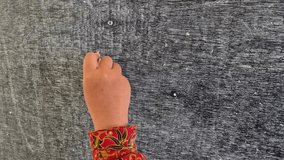 The hand of a female elementary school student is writing numbers on the classroom board using chalk.  - Powered by Shutterstock - Get 15% off with code: PIKWIZARD15