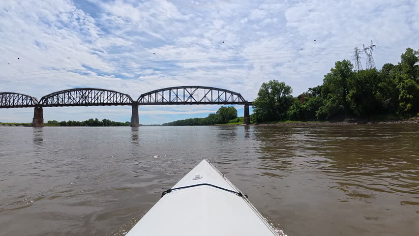 Paddling on the Missouri River under railroad bridge near Fort Osage - POV from kayak or canoe
