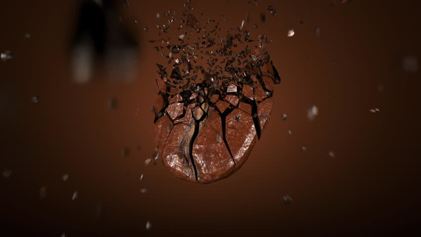 Coffee bean is shown in mid air, dramatically cracking and shattering into pieces against rich brown background, symbolizing energy and intensity