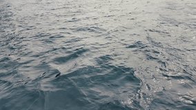 Close-up view of gentle East River waves in slow motion, sunlight glimmering on the rippling water surface. The soft, rhythmic movement captures the tranquil yet dynamic energy of New York City’s icon - Powered by Shutterstock - Get 15% off with code: PIKWIZARD15