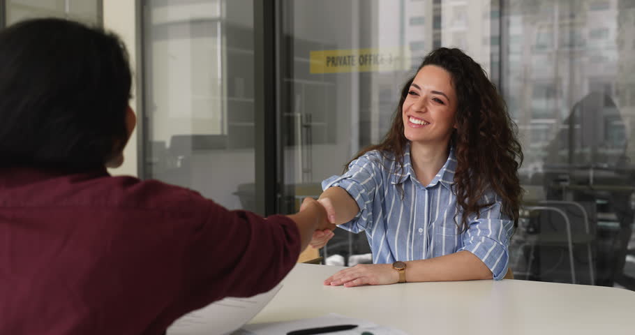 Applicant passing job interview, shaking hands with HR manager, expressing mutual respect, finalizing hiring process successfully. Headhunter holds cv, handshakes candidate, feel satisfied with choice