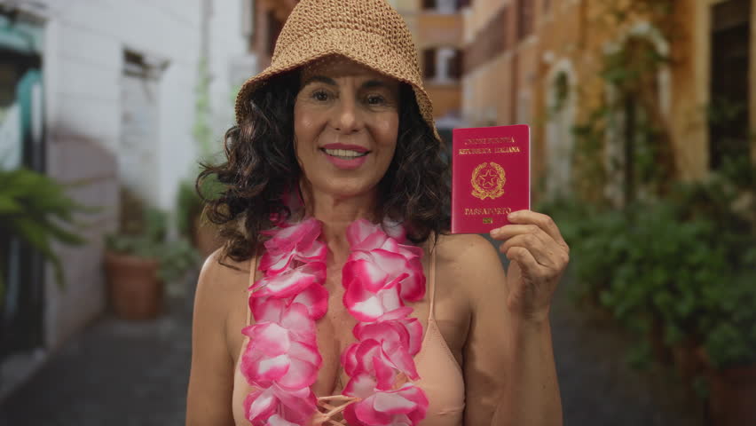 Woman smiling in bikini with lei and straw hat holds italian passport on a sunny street, showcasing vibrant and joyful travel vibes.